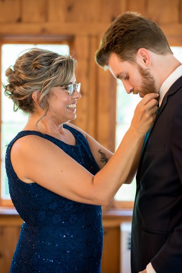 Mother helping son before wedding ceremony St Louis