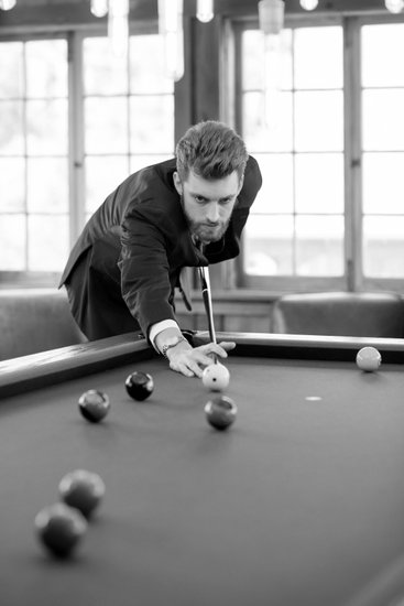 Groom playing pool at Stone House of St Charles