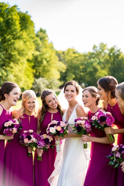 Candid photo of bride with bridesmaids outside