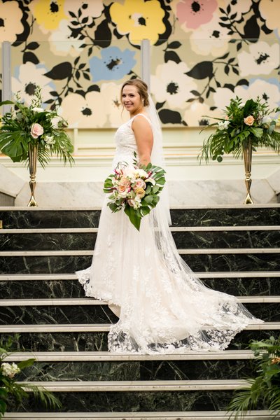 Bride on staircase at Majorette with Leshers Bouquet