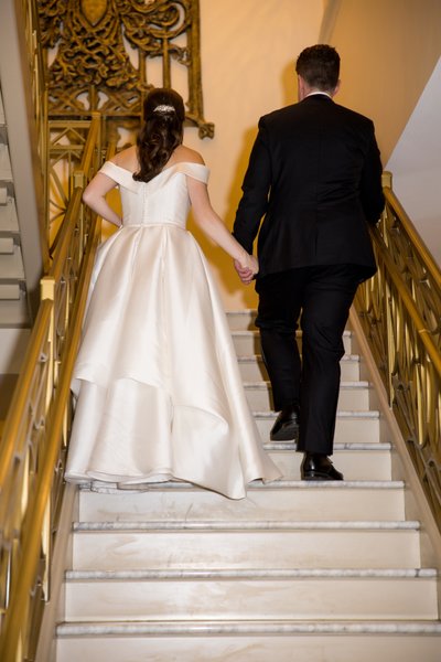Bride and groom on stairs at Hotel Saint Louis