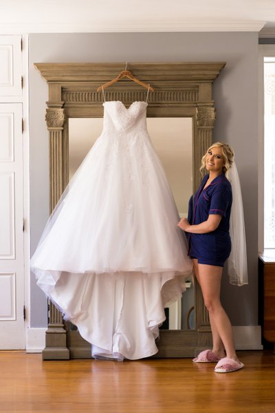 Bride with wedding dress on mirror in St Charles, MO