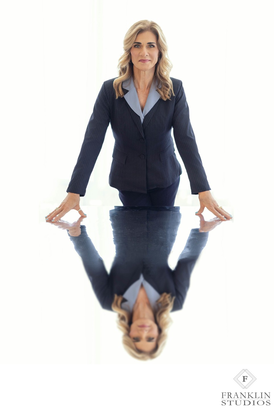Professional-woman-business-portrait-standing-table