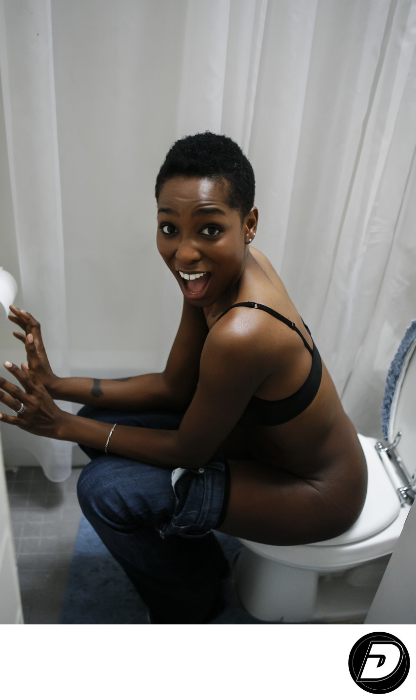 Surprised Looking Woman Sitting On Toilet Photographer