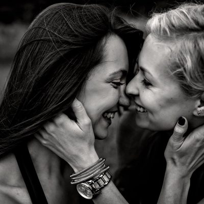 Two recently engaged women happily embracing