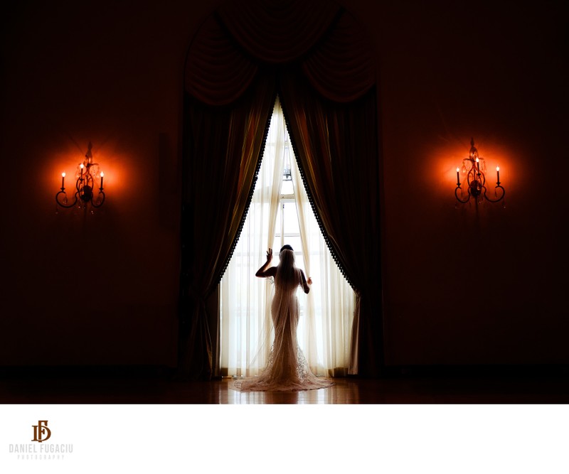 Bride opening curtains at Franklin Institute