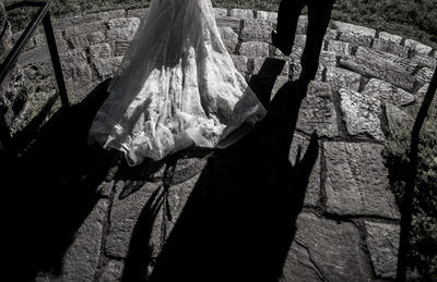 Long shaddows of bride and groom walking
