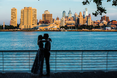 A hug and a kiss in front of the Philadelphia skyline