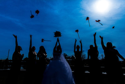 Bride and Bridesmaids throwing Bouquets in the air 