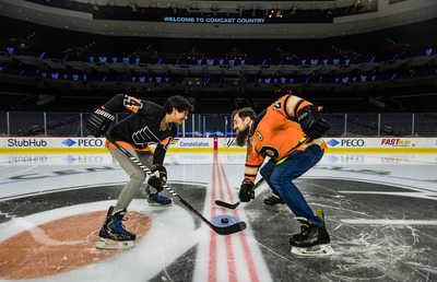 Engaged couple face-off on ice at Flyers Wells Fargo