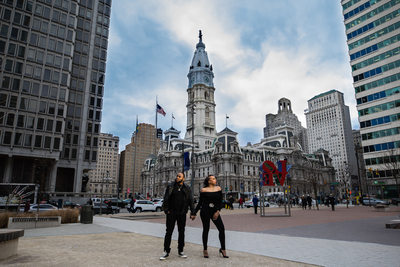 Engaged couple holding hands at Philadelphia City Hall