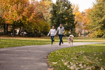 Couple running with their dog
