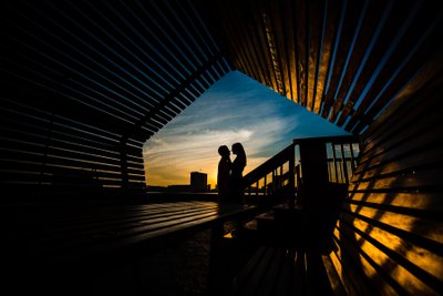 Silhouette of an engaged couple at sunrise