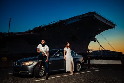 Engaged couple posing with their BMW by Navy Yard