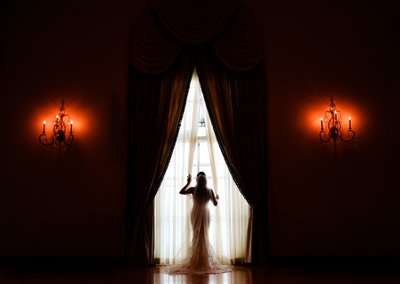 Bride opening curtains at Franklin Institute