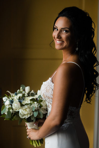 Portrait of bride holding flowers during getting ready
