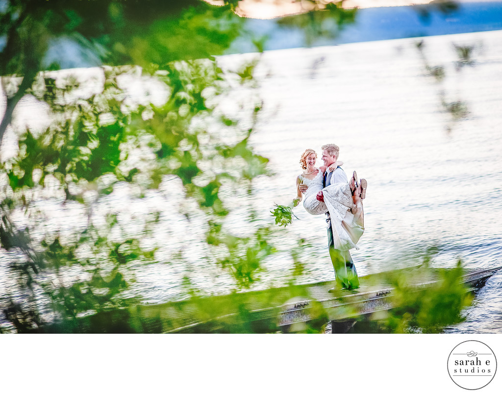 Epic Photo of Bride and Groom on Dock at Lake