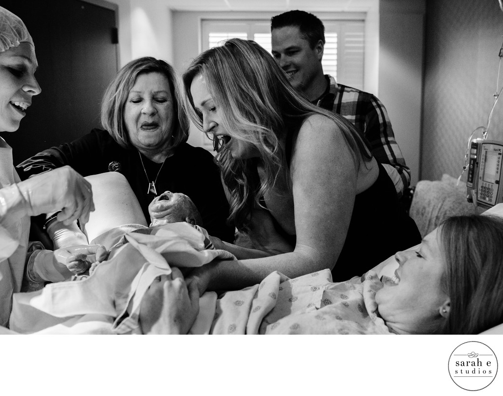 Mom Holding Baby Girl After Surrogate Delivers