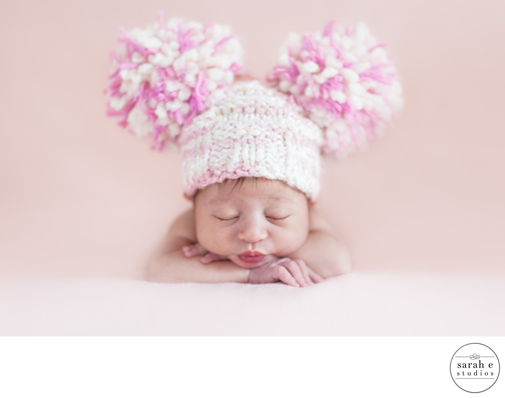 Newborn Girl in Fenton, MO Wearing a Pom Pom Hat