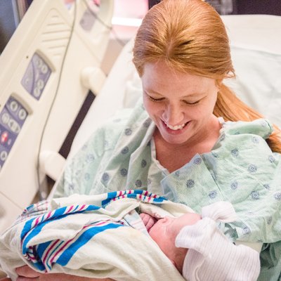 Surrogate Birth Mom Holding Newborn Baby Girl in St. Louis