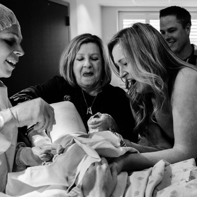Mom Holding Baby Girl After Surrogate Delivers