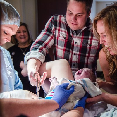 Dad Cutting Cord During Surrogate Birth Story in St. Louis