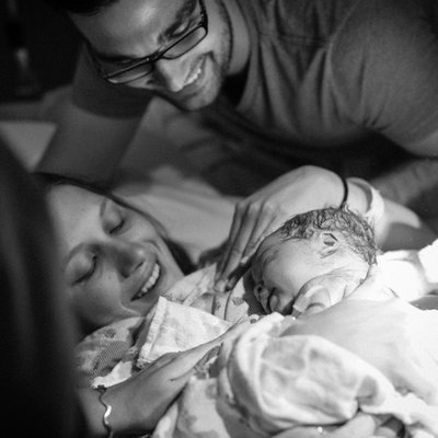 Mom Holding Baby Girl Seconds After Delivery