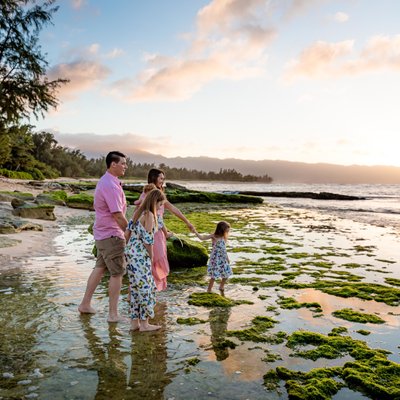 Family enjoying the sunset on a beautiful beach in Hawaii, Oahu