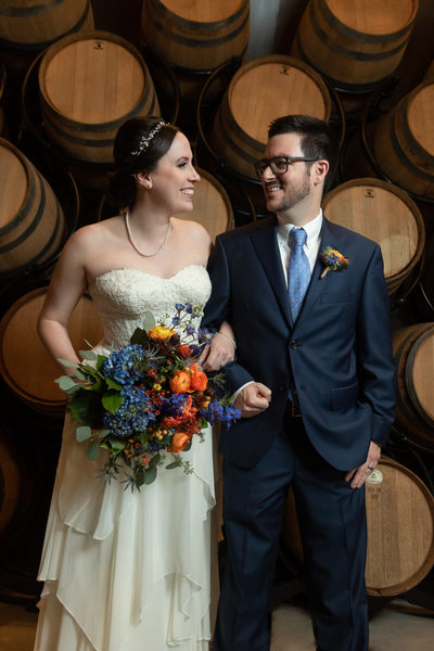 The barrel room with bride and groom