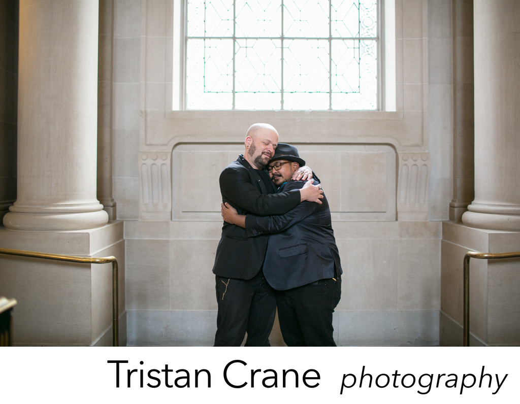 Grooms embrace after their San Francisco City Hall wedding