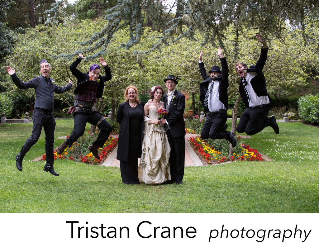Wedding party jump for joy at the Shakespeare Garden
