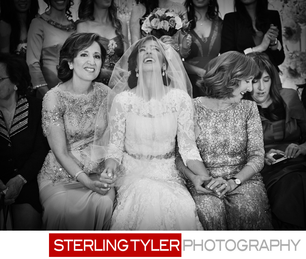 excited jewish bride during bedeken black and white photograph