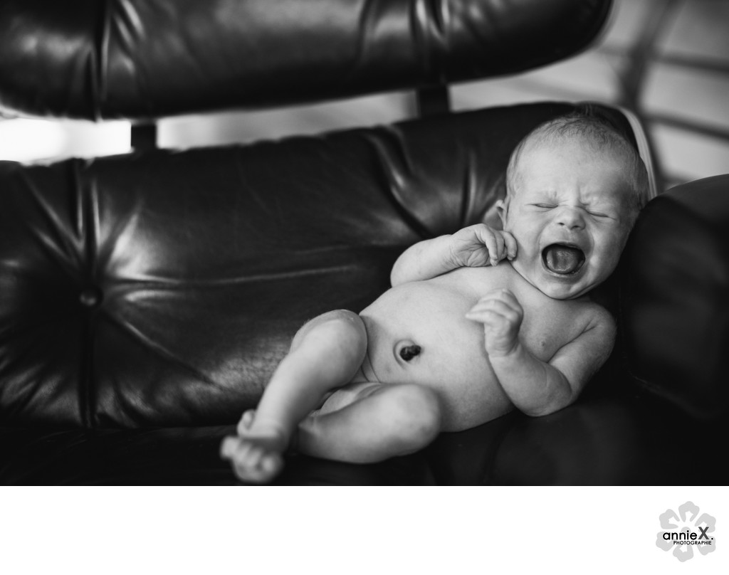 Newborn crying in mid century chair