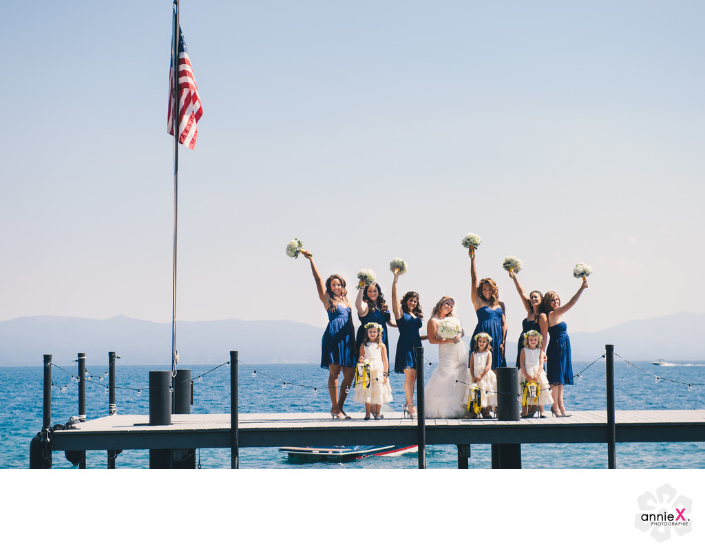Playful bridesmaids on pier