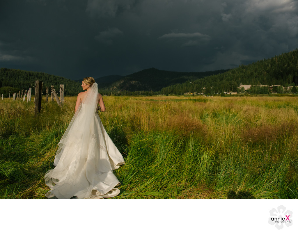 bride in Squaw Valley meadow with stormy skies