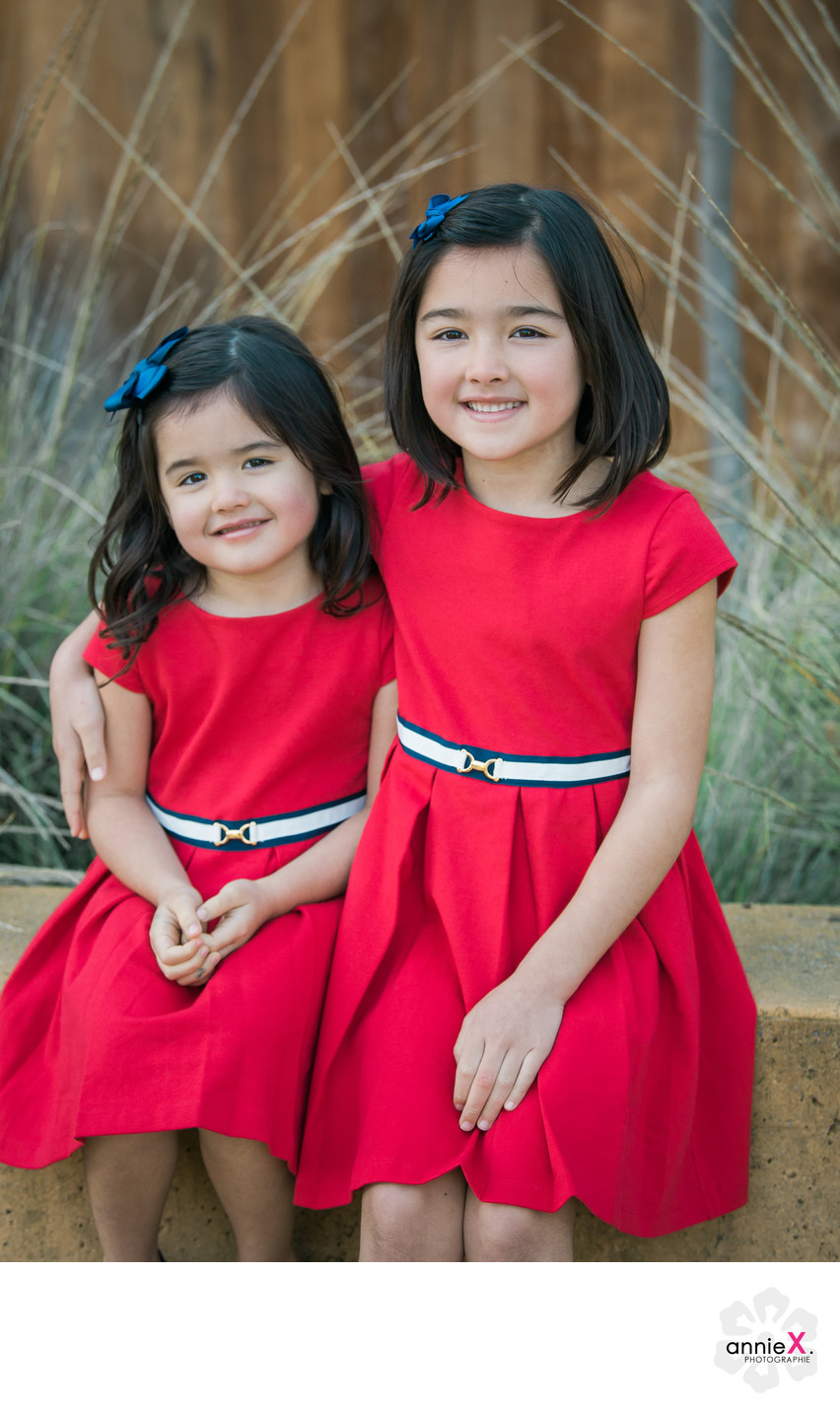 Cute siblings in red dresses