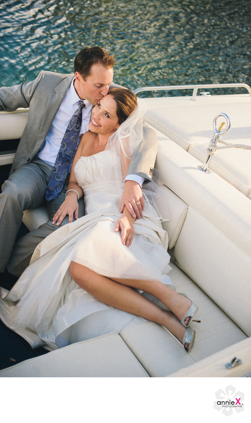 Bride and groom getting comfy in boat at West Shore 