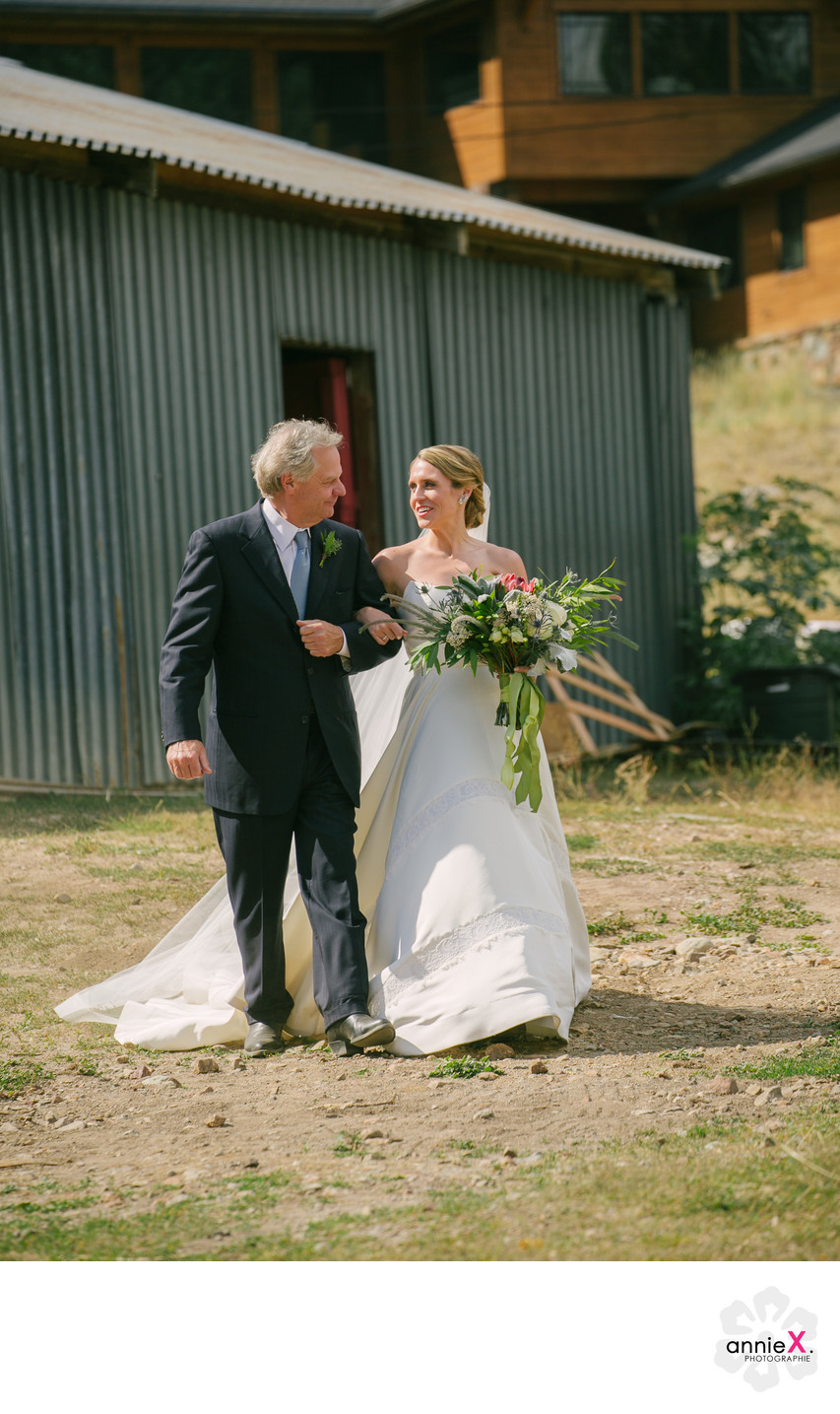 father and bride walking to ceremony at the Stables