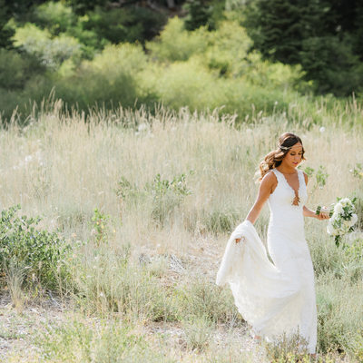Bride walking in field at Ritz Carlton