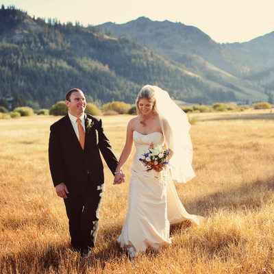 newlyweds stroll in Squaw Valley meadow in fall