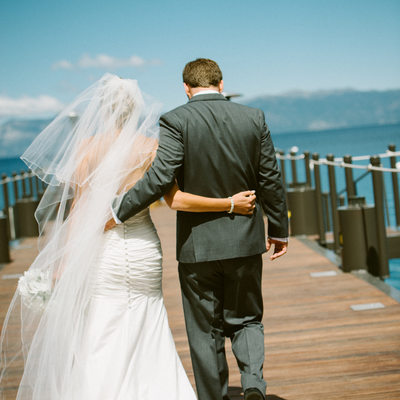 newlyweds walking on West Shore cafe pier