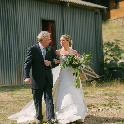 father and bride walking to ceremony at the Stables