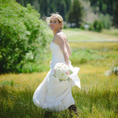 bride with cowboys running in meadow