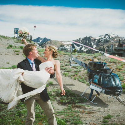 Newlyweds on top of Squaw with helicopter