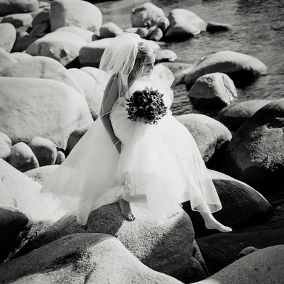 Black and white  bride  on boulders in Lake Tahoe