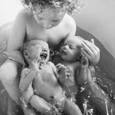 Boy with newborn twins in truckee