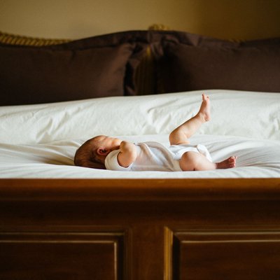 Baby girl on big bed