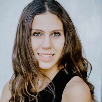 teen girl actor headshot smiling with white backdrop