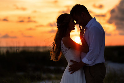 couple embrace sunset portrait session anna maria island