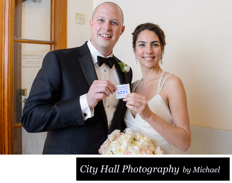 Bride and groom holding number at the County Clerks Office